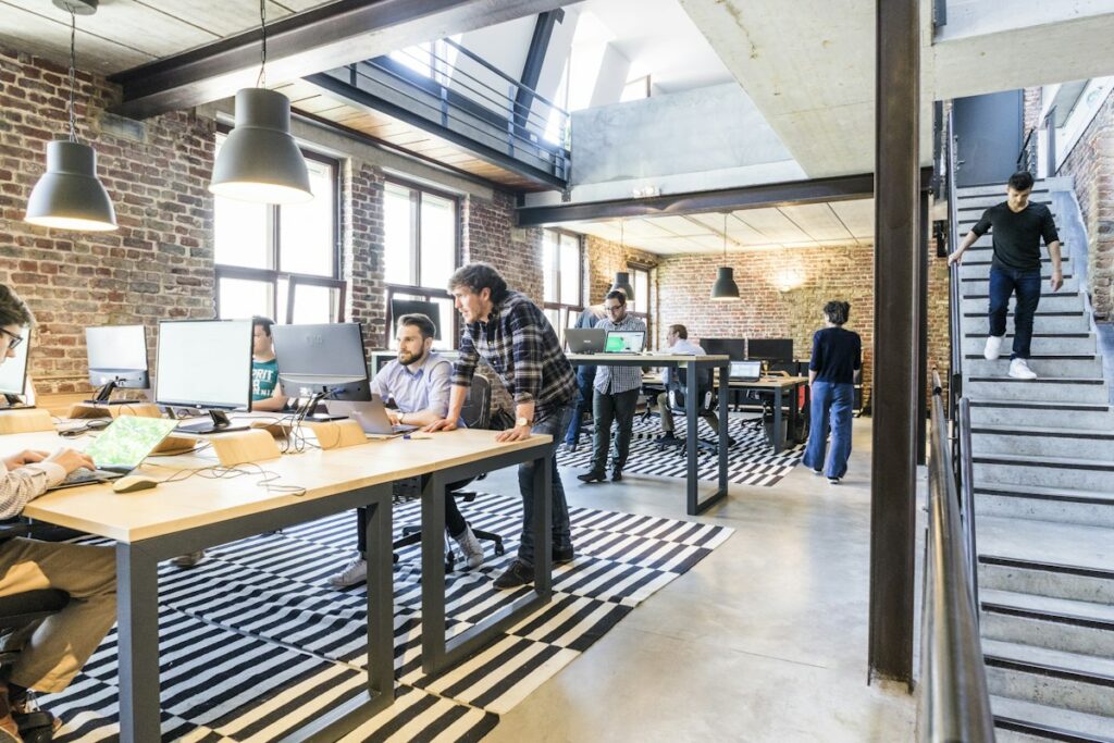 Team working on desktops and laptops in a modern office – IT equipment rental for businesses in the UAE