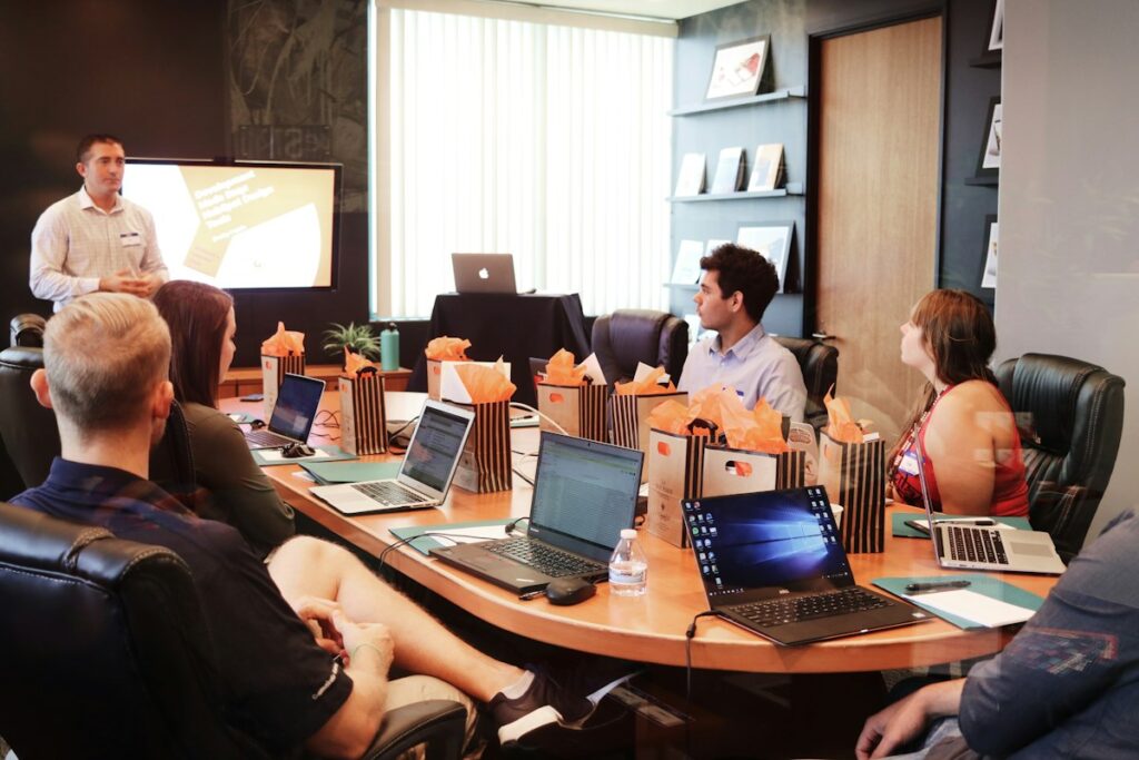 Trainer presenting to a group using laptops – laptop rental for training and bootcamps in Dubai